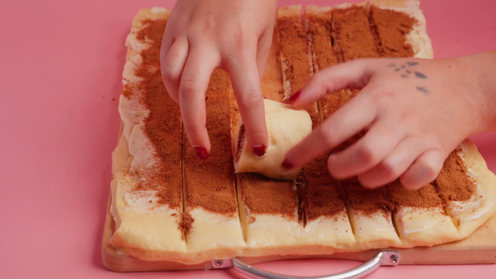Pink studio set, a hand placing a dessert