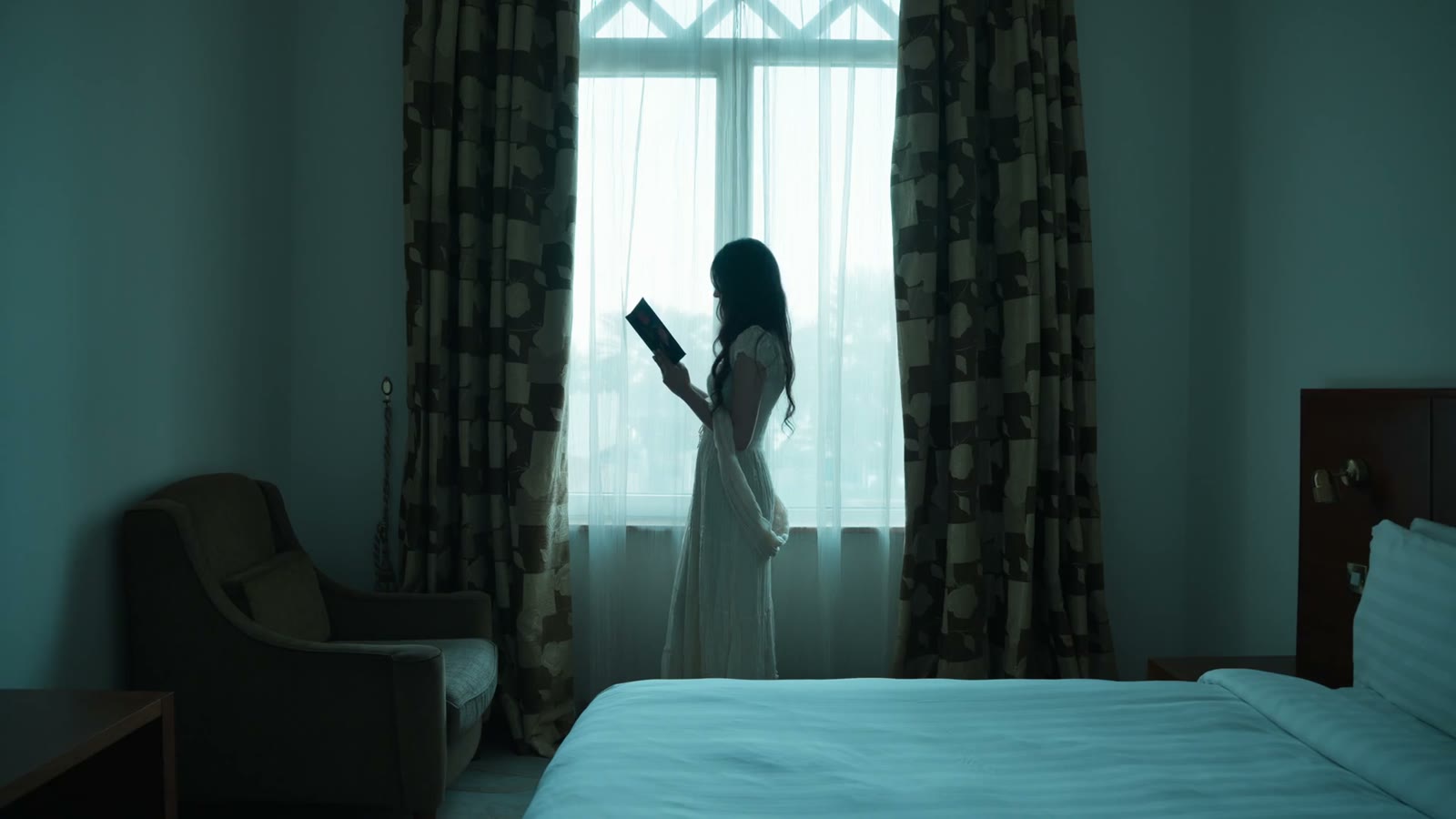 Figure in a white robe in a sunlit interior